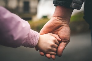Child and Parent Holding Hands