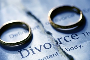 Two Wedding Bands Sitting on Ripped Divorce Document