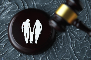 A family with a child on a gavel, representing a Child Custody Attorney in Pekin IL