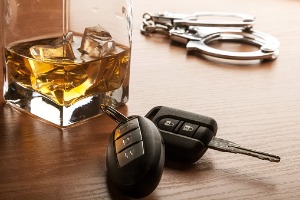 DUI Lawyer Peoria County IL with Keys, Handcuffs, and a Drink